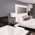 Lotus Boutique Inn & Suites room with ocean-view balcony, king bed, and soaking tub in Ormond Beach