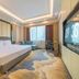 Huahai Hotel Maoming high speed railway station room with king bed, sofa, desk and large window view