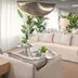 Una Hotels Forte Dei Marmi lounge with cream sofas, potted plants and large windows in Forte dei Marmi