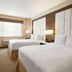 Wyndham Anaheim Hotel in Anaheim guest room with two beds, desk, and large window