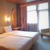 Estalagem Vianorte in Matosinhos hotel room with two twin beds, wall sconces and a window seat