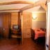 Residence Ruetoreif in Gressoney-Saint-Jean room with wood beams, bed, window and seating area