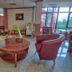 Park Hotel Arbanassi lounge with red armchairs, round table, play area and large windows in Arbanasi