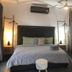 Radio Tulum room with king bed, wall-mounted AC, ceiling fan, and daybed in Tulum