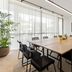 Basq House Byron Bay meeting room with large conference table, wall-mounted TV, and floor-to-ceiling windows