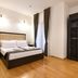 Boutique Hotel Kredo Herceg Novi bedroom with king bed, wood floor, curtains and wardrobe