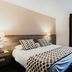 Sure Hotel by Best Western Limoges Sud in Feytiat: modern guest room with double bed, polka dot bedding, and window curtains