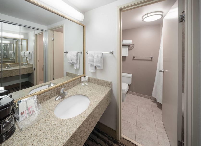 Endeavor Inn & Suites, Trademark Collection by Wyndham in Topeka bathroom with granite vanity and separate toilet room