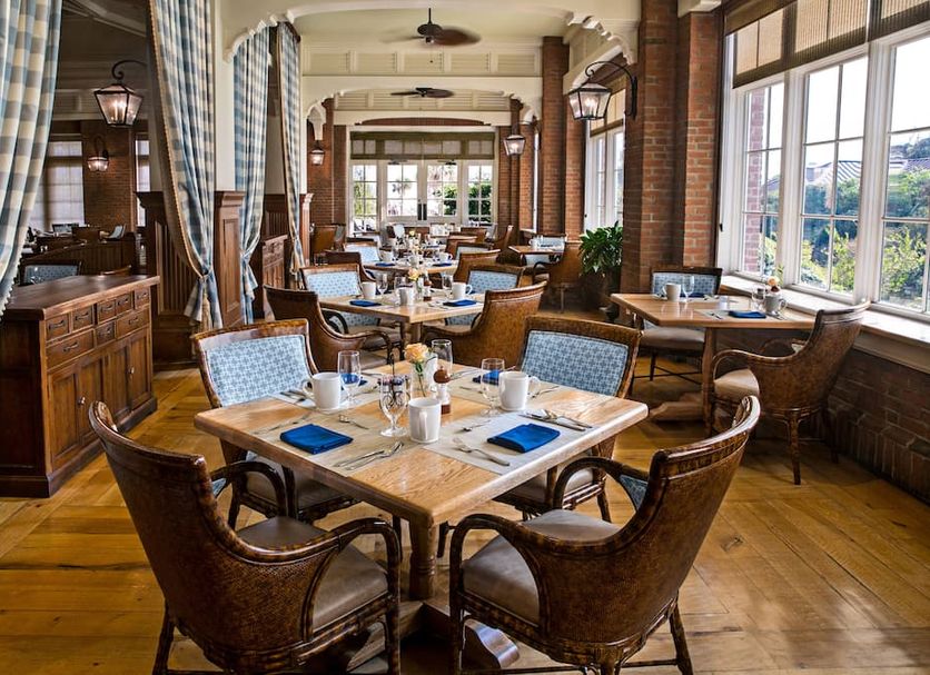The Sanctuary At Kiawah Island Golf Resort dining room with tables and large windows in Kiawah Island
