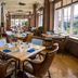 The Sanctuary At Kiawah Island Golf Resort dining room with tables and large windows in Kiawah Island