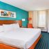 Fairfield Inn & Suites by Marriott Galesburg guest room with king bed, desk, chair and bright window