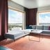 Solo Sokos Hotel Torni Tampere suite with floor-to-ceiling windows and city view in Tampere