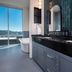 Hotel Indigo Asheville Downtown bathroom with double vanity and bathtub by window overlooking Asheville