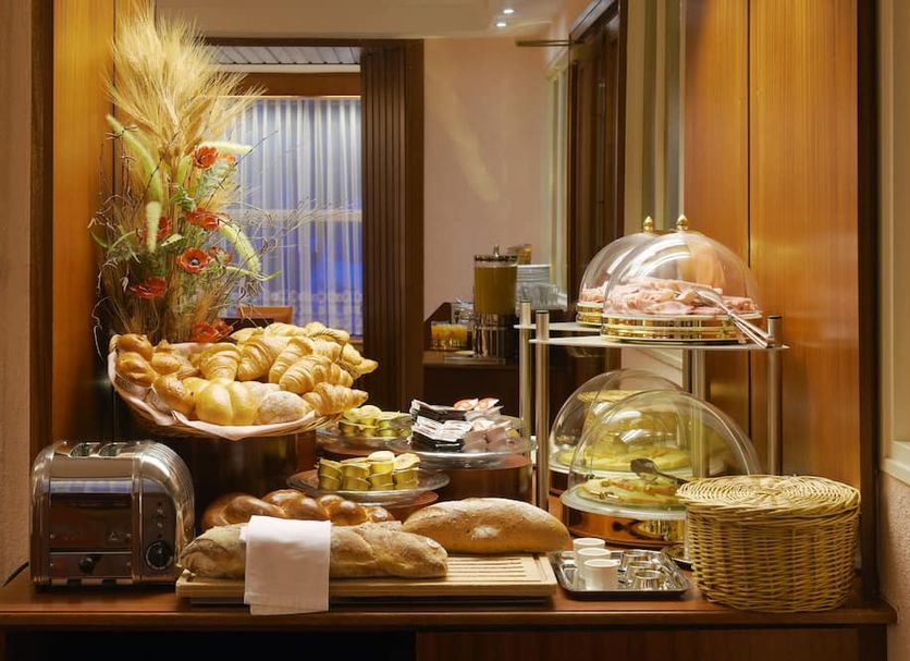 Hotel Elite Lausanne breakfast buffet with pastries, bread, toaster and covered serving trays