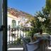 La Venecia de Canarias Puerto de Mogan terrace with table, chairs, potted flowers and mountain view in Mogán
