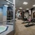 Residence Inn by Marriott Kingston Water's Edge fitness center with treadmills, weights, and an indoor pool view