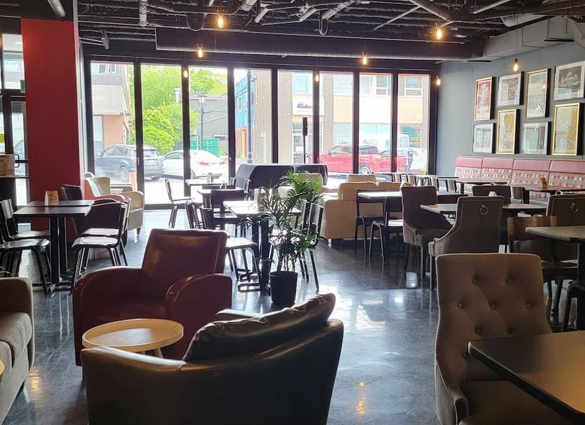 The Arts Hotel in Charlottetown dining area with large windows and framed wall art