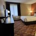 Baymont by Wyndham Plainfield/ Indianapolis Arpt Area guest room with king bed, TV, and window seating