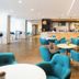 Holiday Inn London - Gatwick Airport By IHG lounge with turquoise chairs and bar seating in Gatwick