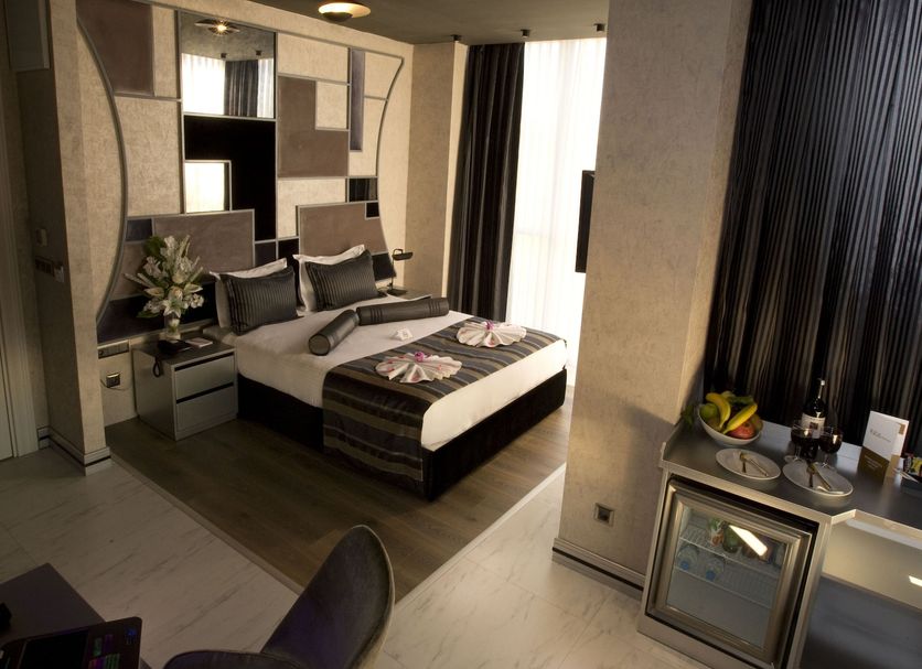 Rios Edition Hotel Istanbul guest room with double bed, desk, and large window drapes