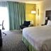 Holiday Inn Express Boca Raton-West by IHG guest room with king bed, chair, desk, and window curtains