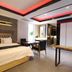 Daegu Innovalley in Daegu: modern guest room with king bed, desk, and red-accented ceiling lighting