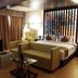 Hotel Le Temps Fort in Tiruchirappalli room with sofa, bed, desk and chair