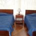 Hostal Bogotá Real, Bogotá: guest room with two twin beds and a bedside table by the window