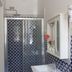 B&B Il Cavaliere in Santa Domenica bathroom with patterned blue tile shower and wall sink