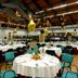 Rhi Porta Bologna in Pieve di Cento banquet hall set with round tables and gold star decorations