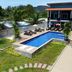 Seashell Resort Krabi in Krabi with outdoor pool, sun loungers, and tropical mountain views