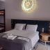 Hospedagem Central in Tiradentes: simple room with double bed, bunk bed, bedside table and wall light