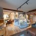 Almwellness Hotel Pierer in Fladnitz: cozy lounge with spiral staircase, sofa, and dining area