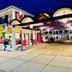 Hotel Zazz in Albuquerque exterior with colorful geometric mural and covered driveway at night