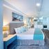 Blue Haven Holiday Apartments in Christchurch, modern studio with bed, kitchenette and wall-mounted TV