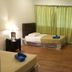 Crystal Hill R in Ranau guest room with twin beds, wood floor, curtains, and TV