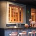 Ignacia Guest House, Mexico City: courtyard bar area with stools, window, and decorative cat statue