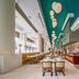 Holiday Inn Shanghai Pudong Kangqiao dining hall with long tables, pendant lights, and buffet counters