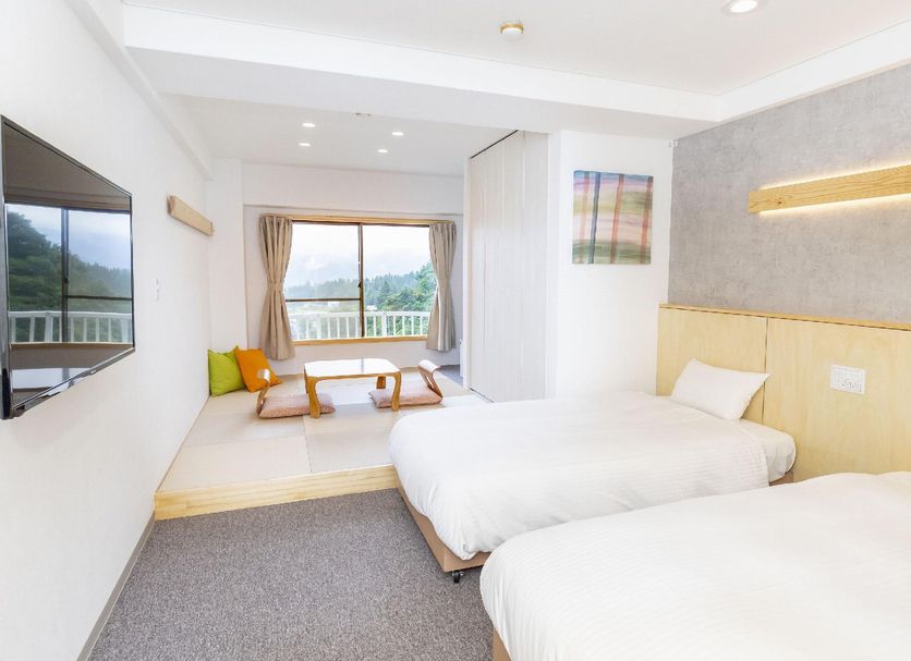 Muika Onsen Hotel in Minamiuonuma guest room with twin beds and balcony mountain view