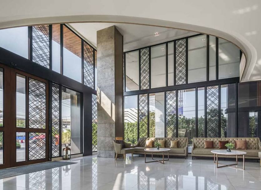 Zayn Hotel Bangkok - Airport Link Access lobby with floor-to-ceiling windows and seating area in Bangkok