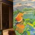 Hostal Los Volcanes in Guatemala City with colorful mural art and a windowed patio area
