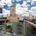 Lym Flat Hotel in Uberlândia balcony view with city skyline and cloudy sky