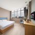 Homeinn Hotel (Anshun Ancient City Gufu Street) room with bed, desk, chair and city view