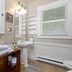 Mountain Meadows Inn & Chalet Suites bathroom in Ashford with pedestal sink, mirror, window blinds, and towels