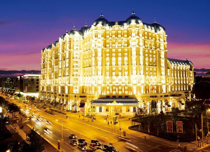 Legendale Hotel Beijing in Beijing, illuminated luxury hotel exterior at dusk on a city street