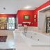 Stone Manor Boutique Inn in Lovettsville: luxurious bathroom with corner soaking tub and red walls