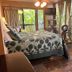 Maui What a Wonderful World Bed & Breakfast Kīhei bedroom with tropical view and rocking chair