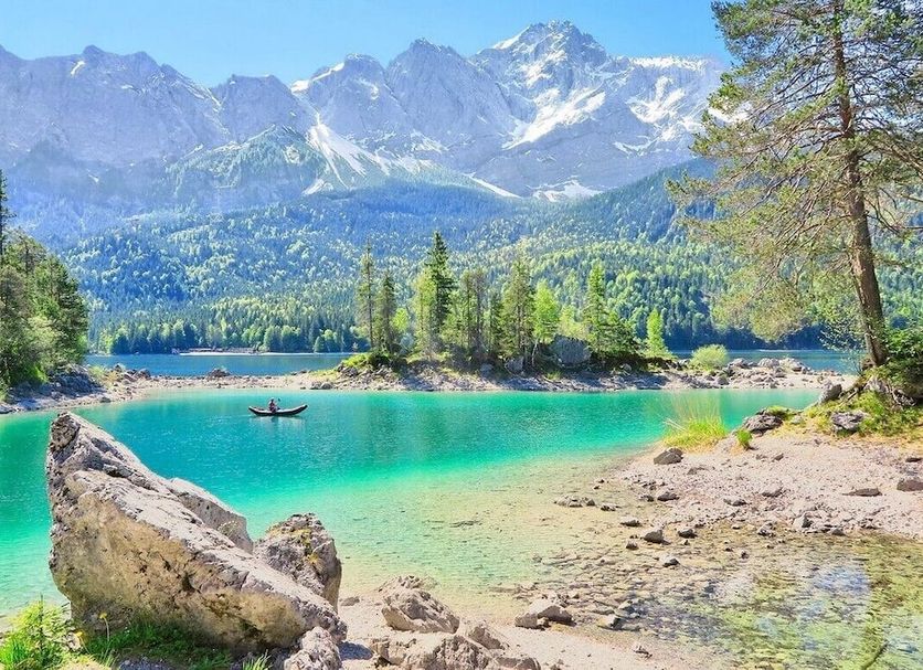 Scenic mountain lake view near Hotel Erzgiesserei Europe in Munich, with turquoise water and forested shore