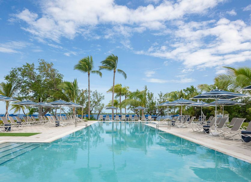 The Capitana Key West poolside oasis with palm trees and lounge chairs in Key West