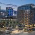 DoubleTree by Hilton Weihai exterior at dusk with illuminated high-rise towers and courtyard